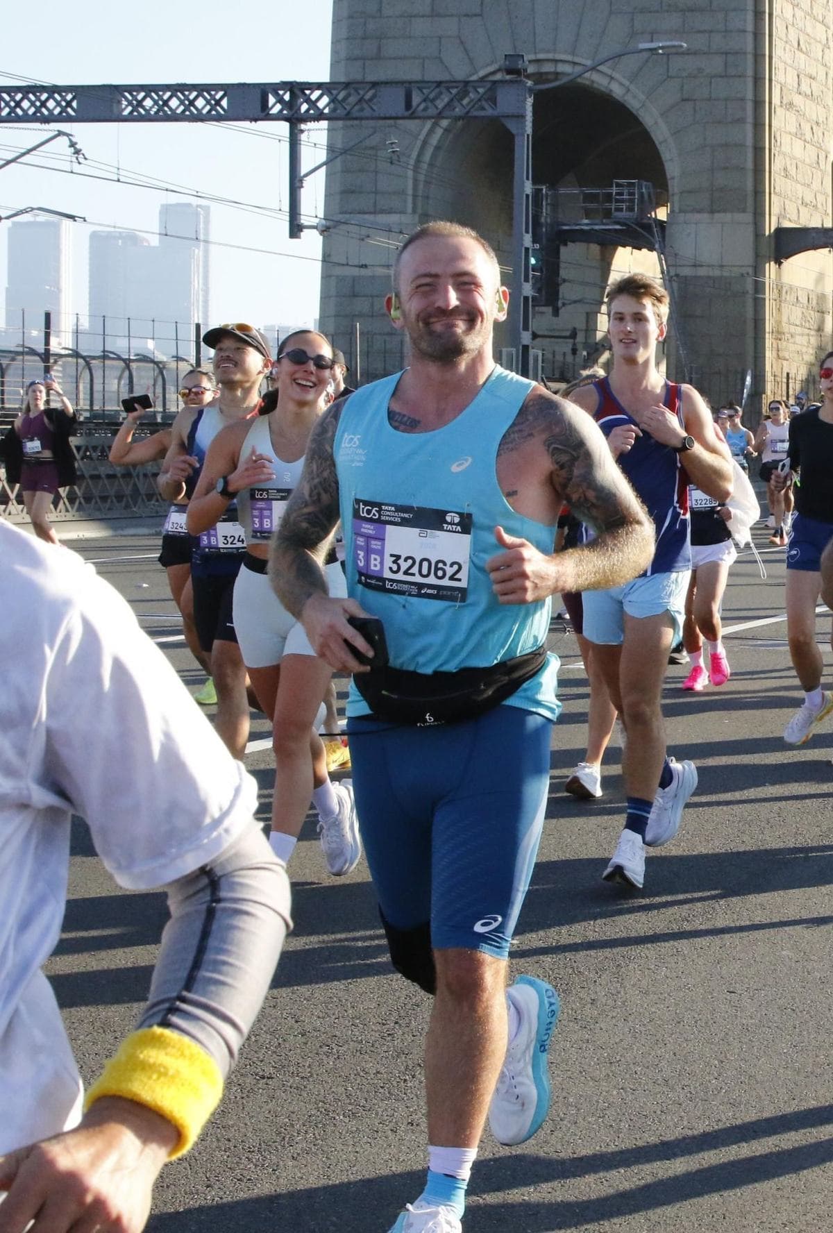Denny running across the Sydney Harbour Bridge during the 2026 marathon